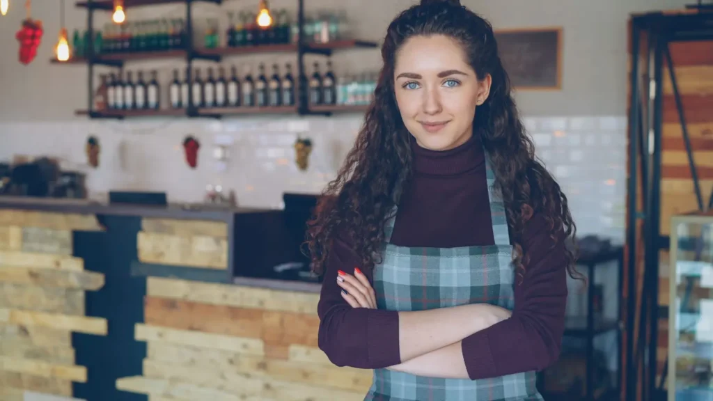 Local SEO services: cafe owner standing with arms crossed inside her shop