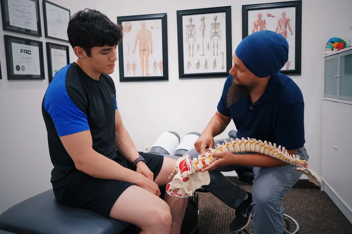 Chiropractor SEO: chiropractor explaining a spine model to a patient