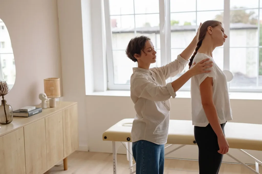 Chiropractor SEO: chiropractor checking a patient's posture in a bright clinic