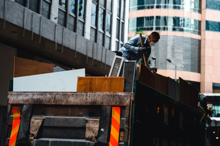 Digital marketing agency: worker loading debris onto a hauling truck