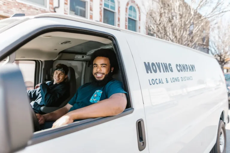 Home services marketing: two movers smiling from a moving company van
