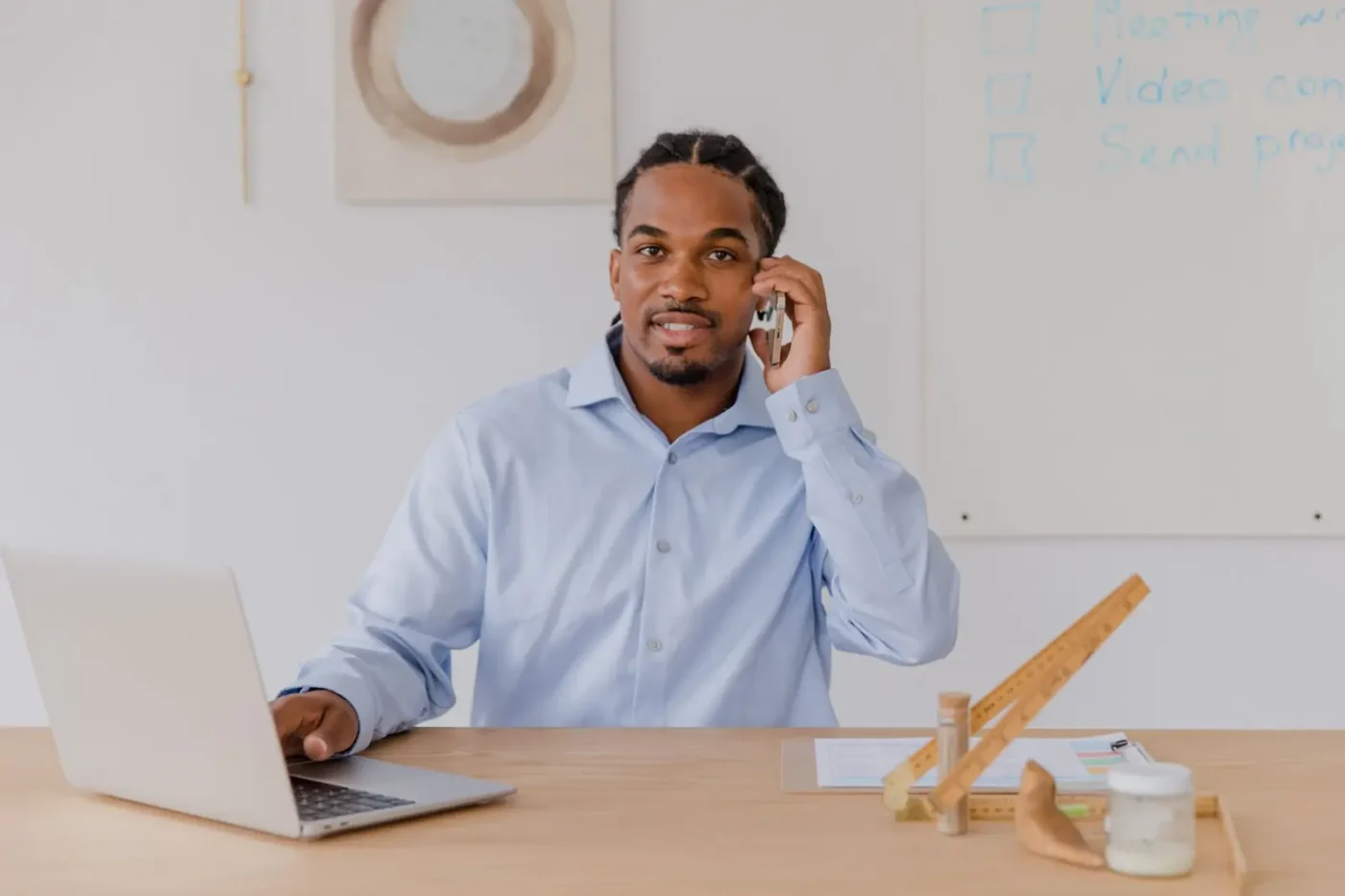 SEO services: business owner on a phone call while working on a laptop