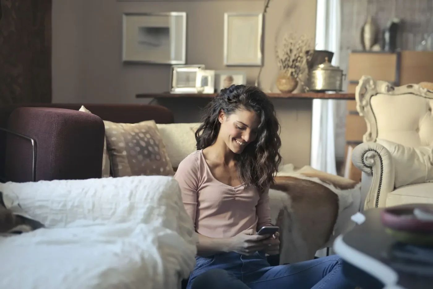 Woman using her phone on a living room sofa AI SEO services: woman using her phone on a living room sofa