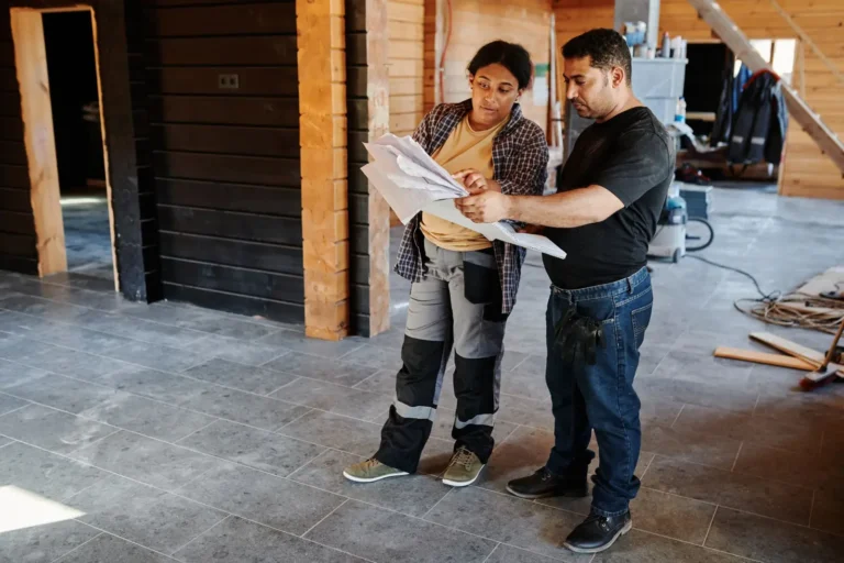 Home services marketing: contractors reviewing plans inside a home under renovation