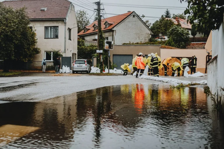 Home services marketing: emergency crews placing sandbags on a flooded residential street