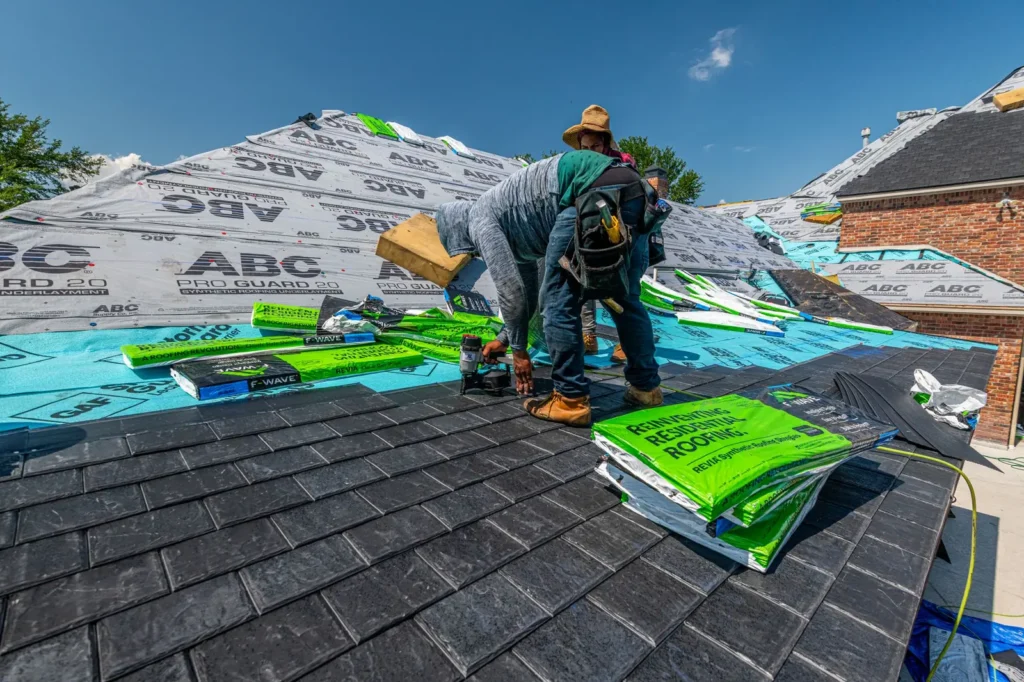 Roofing marketing: roofers installing underlayment and shingles on a house