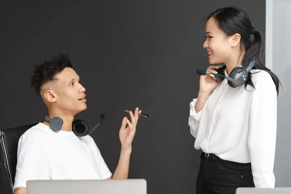 Team members with headsets chatting in the office Reputation management services: team members with headsets chatting in the office