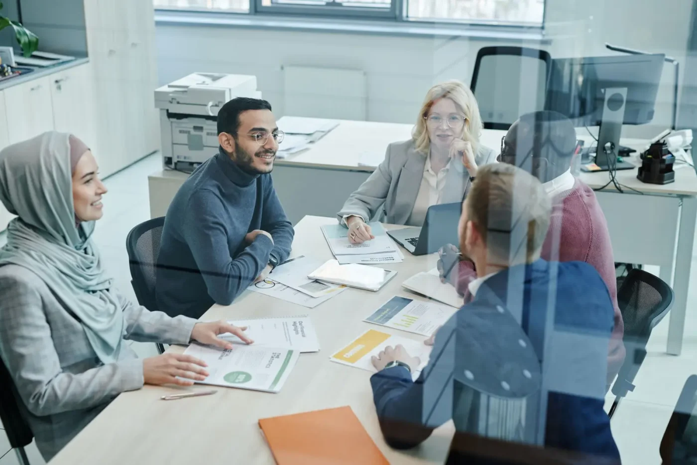 Digital marketing company: marketing team talking through a plan around a conference table